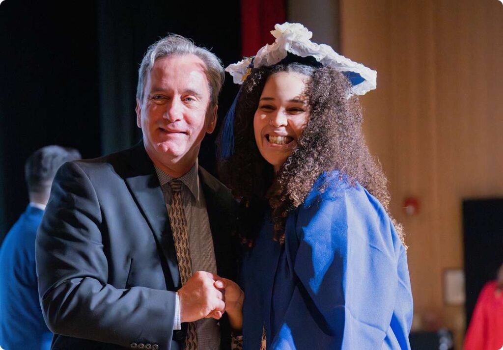 Graduated student with a teacher