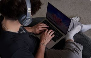 boy writing in the laptop