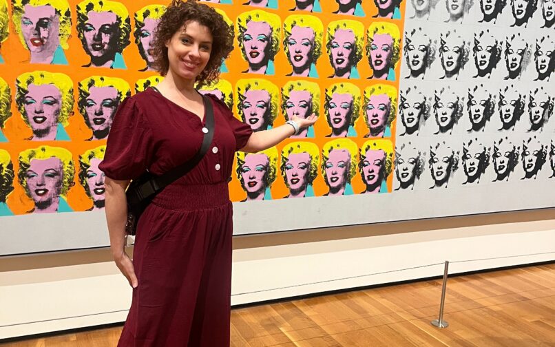 ODLS teacher standing in front of a piece done by Andy Warhol.