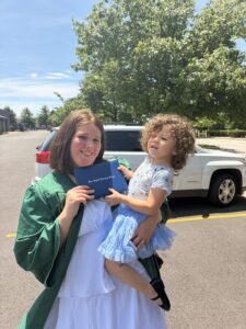 Madalyn holding her daughter at her high school ODLS graduation.