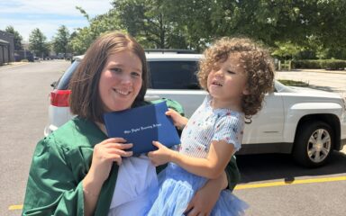 Madalyn holding her daughter at her high school ODLS graduation.